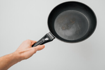 Dirty old non-stick frying pan on white background