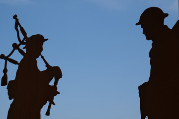 Silhouette of WWI Scottish piper and soldier at Frezenberg Memorial Belgium. World War I metal...