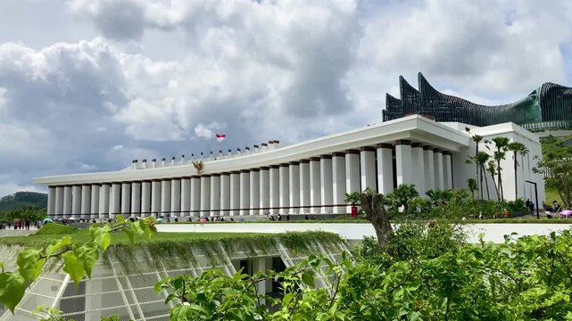 The new Indonesia presidential palace, monumental white government building with long colonnade and indonesian flag