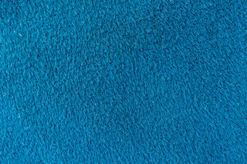 Blue brushed fleece fabric texture with soft velour surface showing warm textile material background for clothing and insulation use © Iryna Miadzvedzeva