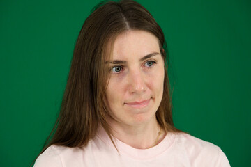 portrait of young woman appears thoughtful as she holds her cellphone, reflecting on something important on light background. High quality photo