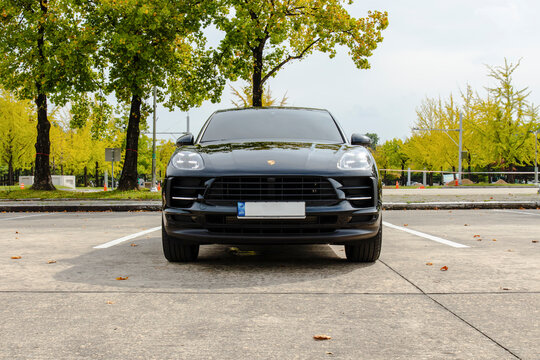 October 9, 2021, Seoul, South Korea - A black Porsche Macan S luxury SUV parked in a parking lot during autumn.