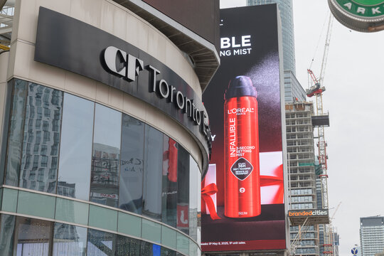 exterior building facade and sign of CF Toronto Eaton Centre with digital billboard feat L&rsquo;Or&eacute;al Infallible Setting Spray and other construction on Yonge St