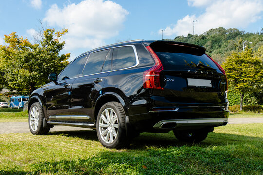 October 20, 2021, Seoul, South Korea - A black Volvo XC90 T6 AWD luxury SUV is parked on a grassy area on a sunny day.