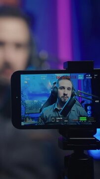 Gamer influencer recording video with smartphone camera