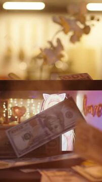 Giving packs of money to VTuber on monitor screen