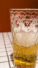 Glass of White Beer on Empty Tile Table. Beverage Indoor Closeup