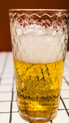 Glass of White Beer on Empty Tile Table. Beverage Indoor Closeup