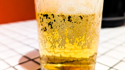 Glass of White Beer on Empty Tile Table. Beverage Indoor Closeup