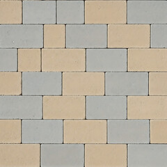 A close up view of interlocking paving stones in gray and tan shades