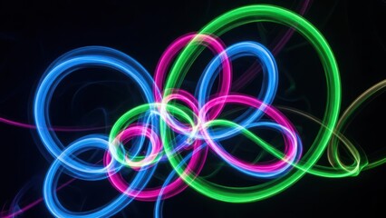 Abstract light trails in neon colors against black background