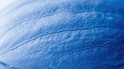Abstract macro view of textured blue surface with linear patterns