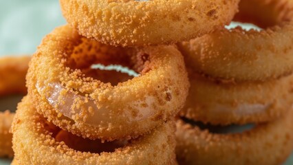Close up of golden fried onion rings in a stack