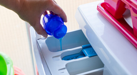 using liquid laundry detergent for washing clothes at home