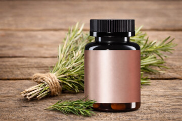Supplement bottle mockup with blank rose-gold label on amber jar, black cap, rosemary on rustic wood. Minimal wellness packaging template, front view, copy space, high-res.