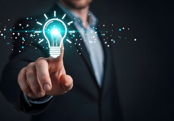 A man in a suit pointing at a glowing lightbulb with sparkling particles on a dark background image