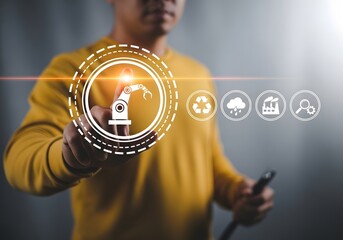Man in yellow shirt interacting with robotic arm symbol and other icons on a virtual interface