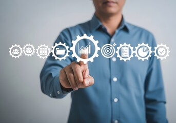 Man pointing at chart icon within gear wheel showcasing business process automation concept image