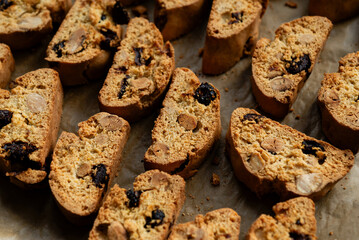 Homemade italian cantuccini biscotti cookies with hazelnuts and dried cranberries on baking paper