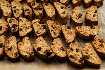 Homemade italian cantuccini biscotti cookies with hazelnuts and dried cranberries on baking paper