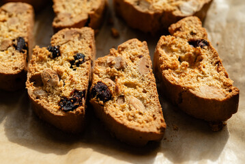 Homemade italian cantuccini biscotti cookies with hazelnuts and dried cranberries on baking paper