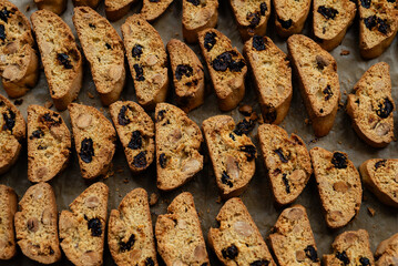 Homemade italian cantuccini biscotti cookies with hazelnuts and dried cranberries on baking paper