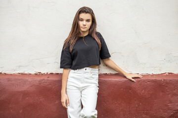 Portrait of a young beautiful brunette girl, outdoors