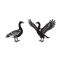 Fototapeta premium Two black geese silhouettes one standing one with wings spread goose bird