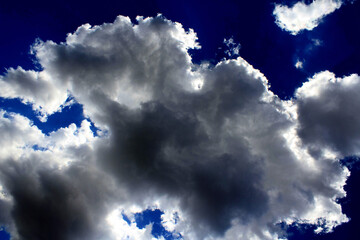 A vibrant blue sky streaked with dynamic clouds