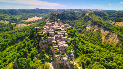 Panoramic aerial view of Civita di Bagnoregio from a flying drone around the medieval city, Italy.