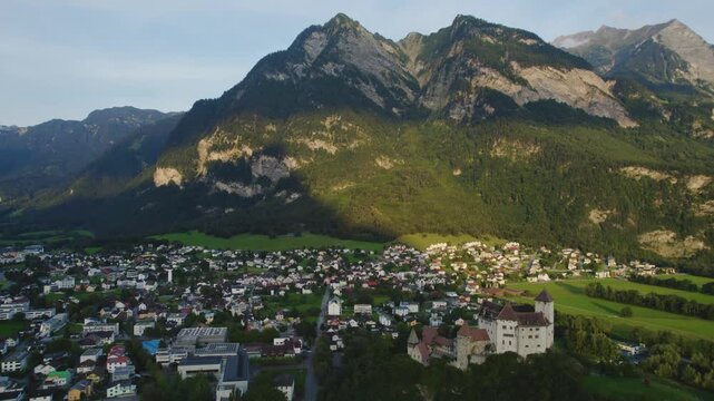 Aerial view around the village Balzers in Liechtenstein beside Switzerland on a cloudy afternoon in summer.
