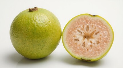 Vibrant green guava fruit whole and sliced on white background showing pink flesh and seeds