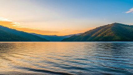 Fototapeta premium Sunset over calm lake and hills