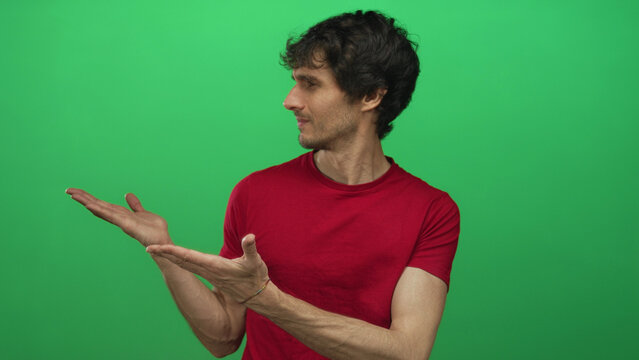 Man in red shirt offering open palms gesture and turned head gaze with skeptical expression in studio; doubt. - Powered by Adobe