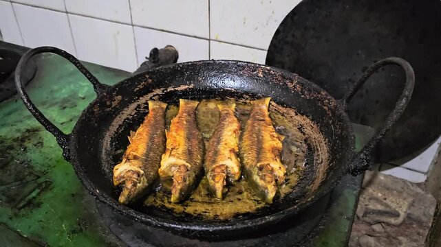 Crispy Whole Pan-Fried Fish Recipe. Traditional Village Style Crispy Fish Fry. Bata fish (Labeo bata). Delicious crispy fried fish in hot oil.