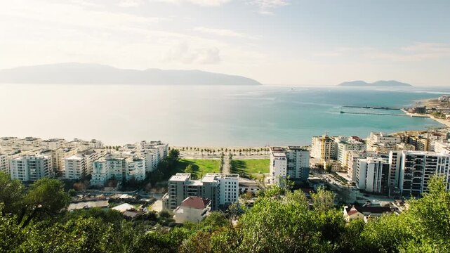 Vlore, Albania &ndash; December 2025: Panoramic view of Vlore showing residential buildings along the Adriatic Sea coastline. Urban cityscape with waterfront area and surrounding hills on a clear day.