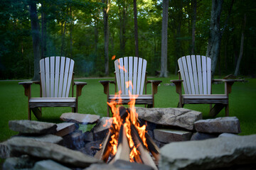 Cozy backyard campfire with adirondack chairs