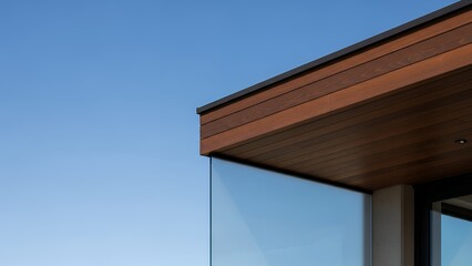 Modern House Exterior with Glass and Wooden Features Under Clear Blue Sky