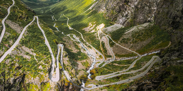 Trollstigen, Andalsnes, Norway. Cars Goes On Serpentine Mountain Road Trollstigen. Famous Norwegian Landmark And Popular Destination. Norwegian County Road 63 In Summer Day. 4K
