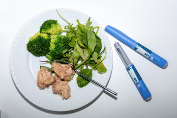 Medical diet concept featuring tuna salad broccoli and Ozempic