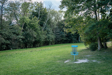 blue discgolf basket in the park