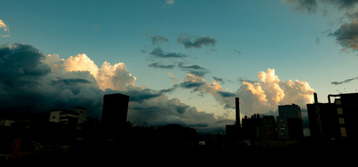 Obraz premium Beautiful cloud, marvelous and magnificent cloud at sunset behind the silhouettes of an industry, selective focus.