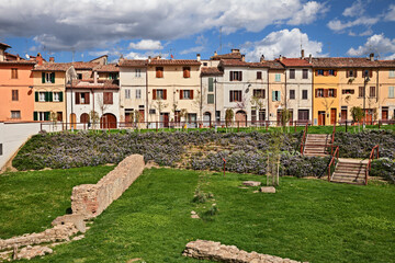 Citta di Castello, Perugia, Umbria, Italy: view of a street with picturesque old houses, a green area and the remains of the ancient city walls