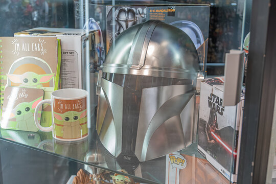 Display case with silver Star Wars Mandalorian helmet, green-bodied figurines, possible promotional box, straightforward style - Kyiv, Ukraine 07-06-2025