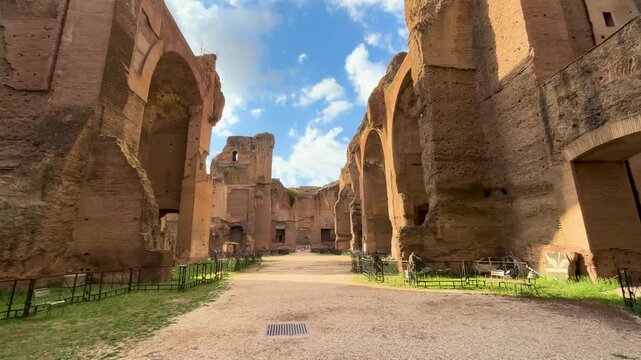 mid path ruines baths caracalla terme rome arched doors columns outgrowing plants them framing adds balance to reveals from long top down view of mid-path outlook 