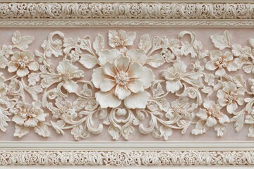 Intricate floral bas-relief molding features detailed blossoms and swirling foliage on a pale background