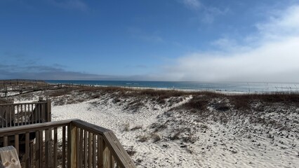 A beautiful winter day at the beach of Gulf Shores, AL: View from the porch showing the dunes and the sea.