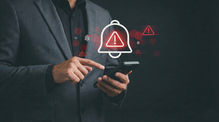 Corporate man handling emergency alert notification on mobile phone, concept of warning message, cyber threat monitoring, digital security breach, urgent system error, and risk management