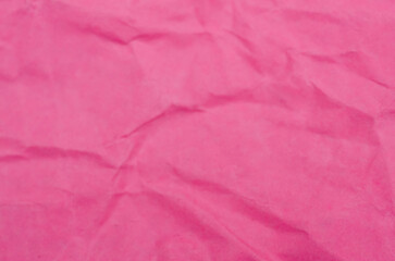 Fototapeta premium Intricate Pink Paper Texture: Sharp Creases and Soft Undulating Folds