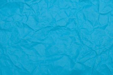 Obraz premium Dense Texture of Jagged Folds and Soft Creases on Bright Blue Paper Surface